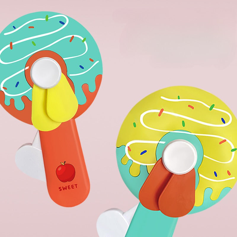Donut Kid Fan – Cute Handheld Mini Fan for Kids | Portable Cartoon Fan for School, Travel & Outdoor Use (Random Color)