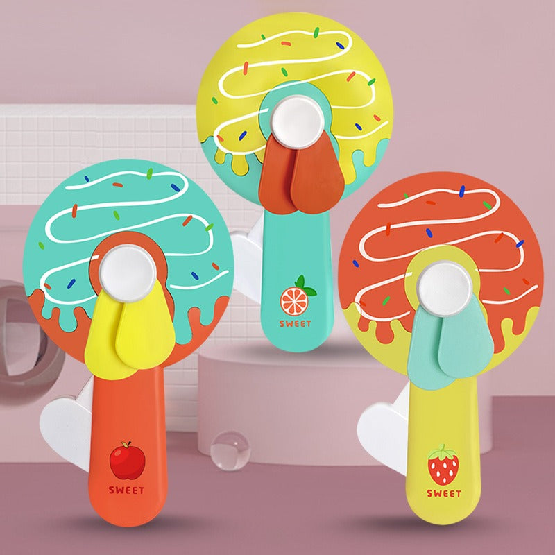Donut Kid Fan – Cute Handheld Mini Fan for Kids | Portable Cartoon Fan for School, Travel & Outdoor Use (Random Color)